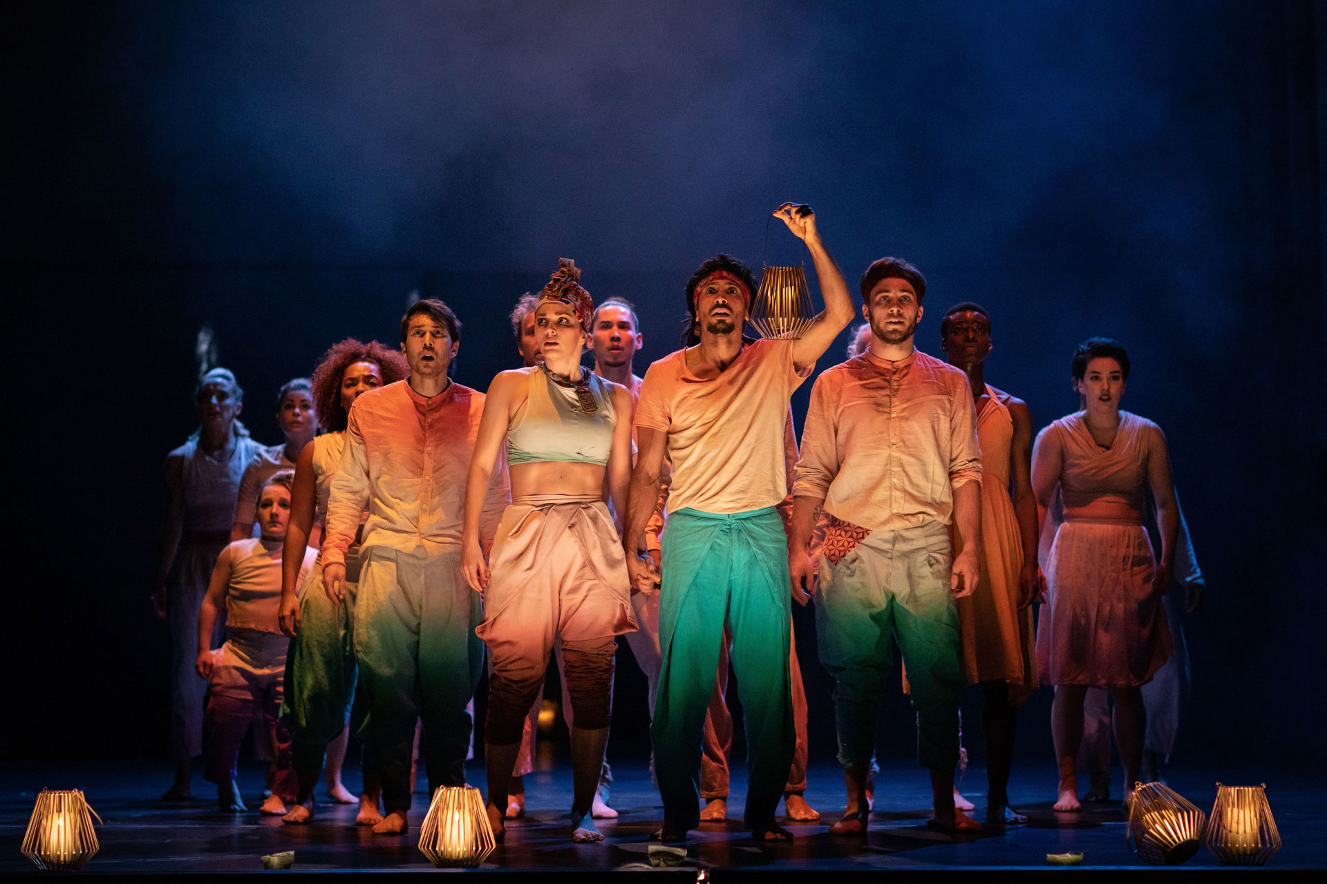 group of dancers on stage for Message in a bottle wearing colourful casual clothes looking out to the audience with one person lifting hand and clicking