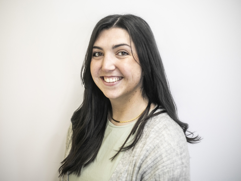 Headshot of Katie Stevens. white female with long dark hair smiling at the camera with light colour clothes Headshot of Katie Stevens. white female with long dark hair smiling at the camera with light colour clothes