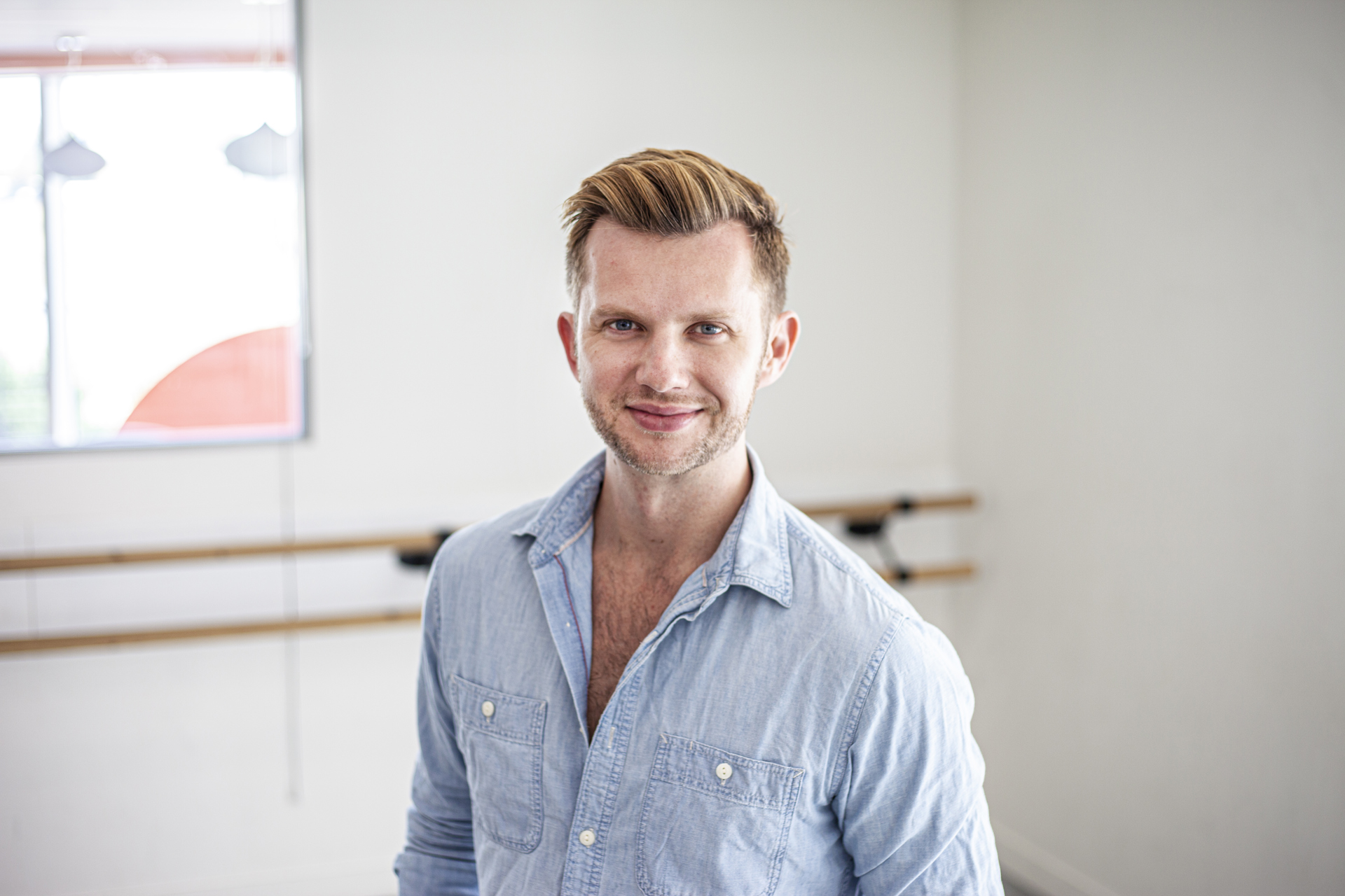 Headshot of Cameron Ball. White blonde male smiling at the camera wearing blue button up shirt  Headshot of Cameron Ball. White blonde male smiling at the camera wearing blue button up shirt