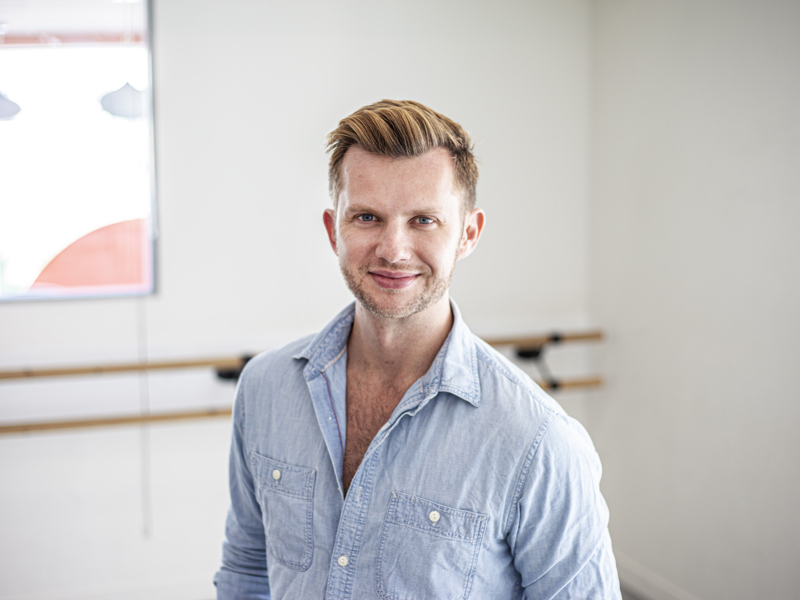 Headshot of Cameron Ball. White blonde male smiling at the camera wearing blue button up shirt  Headshot of Cameron Ball. White blonde male smiling at the camera wearing blue button up shirt