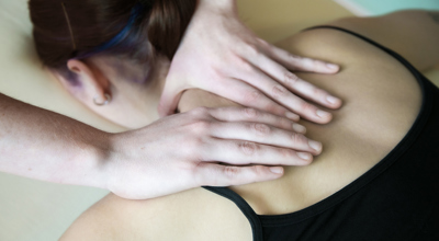 Close up of healthcare practitioners hands massaging dancers sholder Close up of healthcare practitioners hands massaging dancers sholder