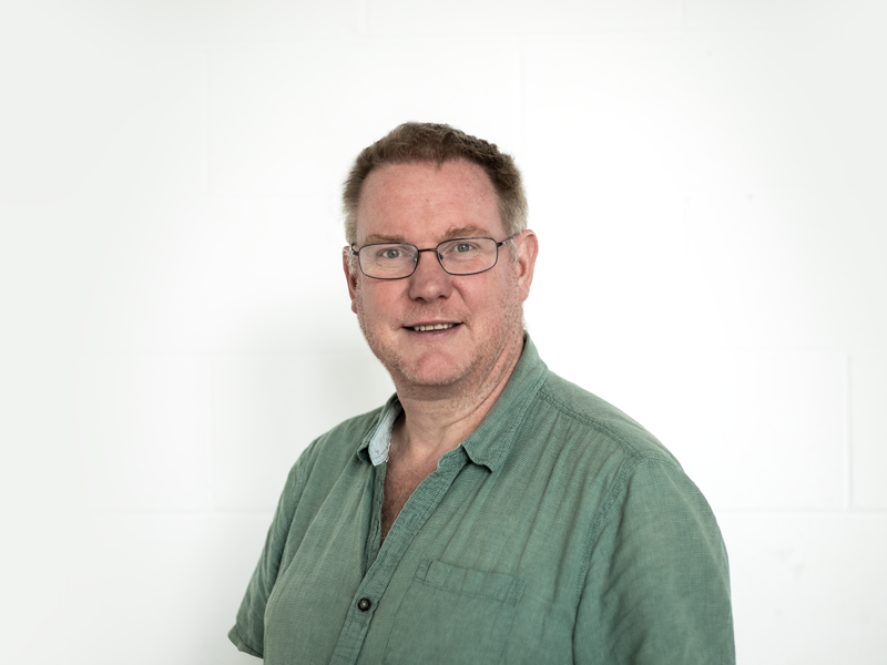 Headshot of Paul Hibbert. White light haired  male smiling at the camera wearing glasses and a green shirt Headshot of Paul Hibbert. White light haired  male smiling at the camera wearing glasses and a green shirt